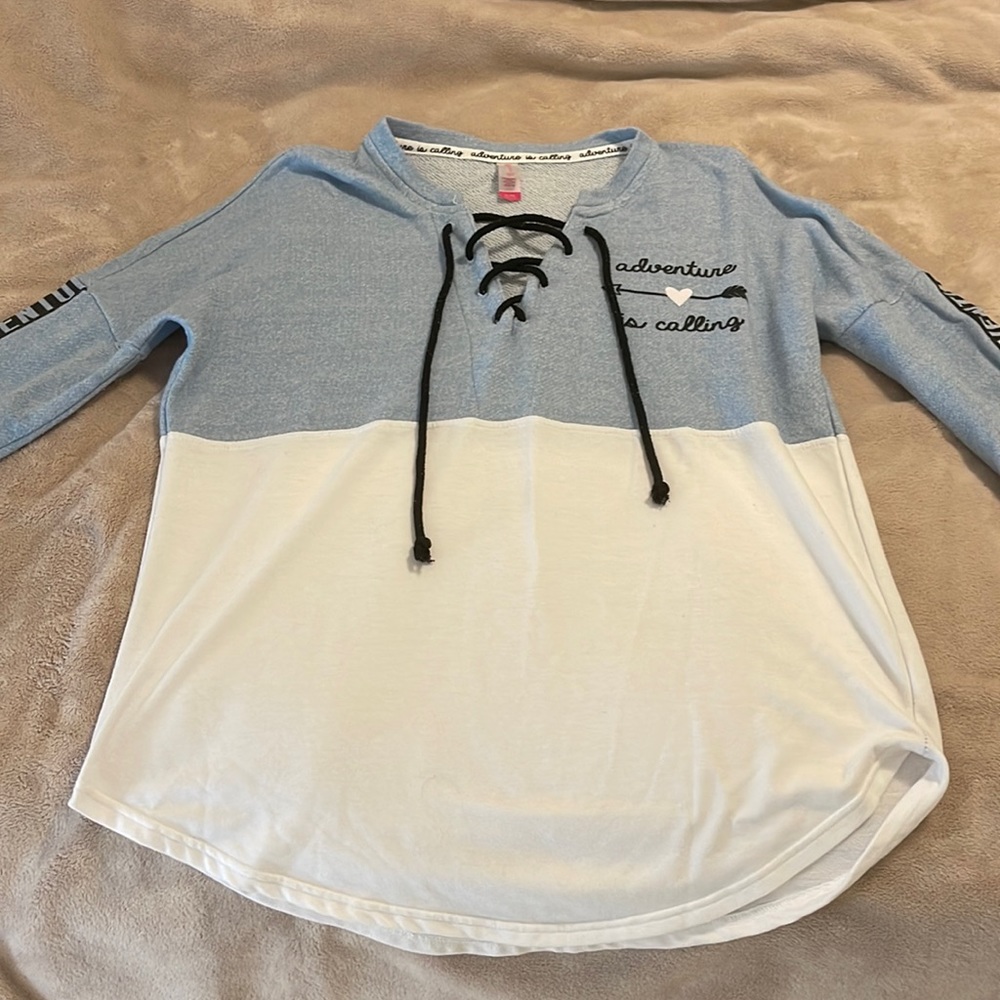 Light blue and no boundaries light pullover with adventure is calling detailing.
